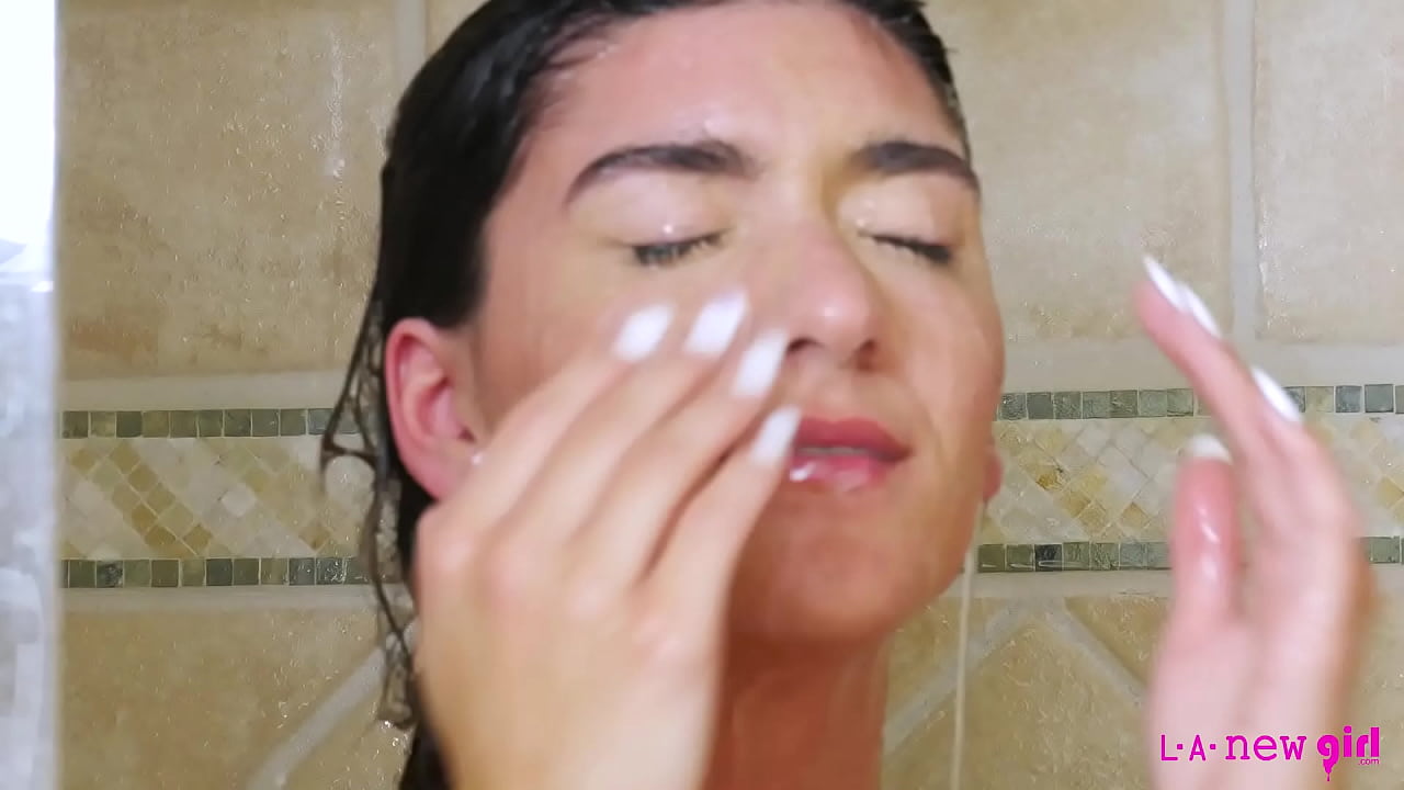 Captivating brunette transforms a simple shower into an alluring tableau