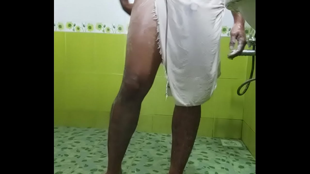 Indian boy in transparent towel taking shower in public