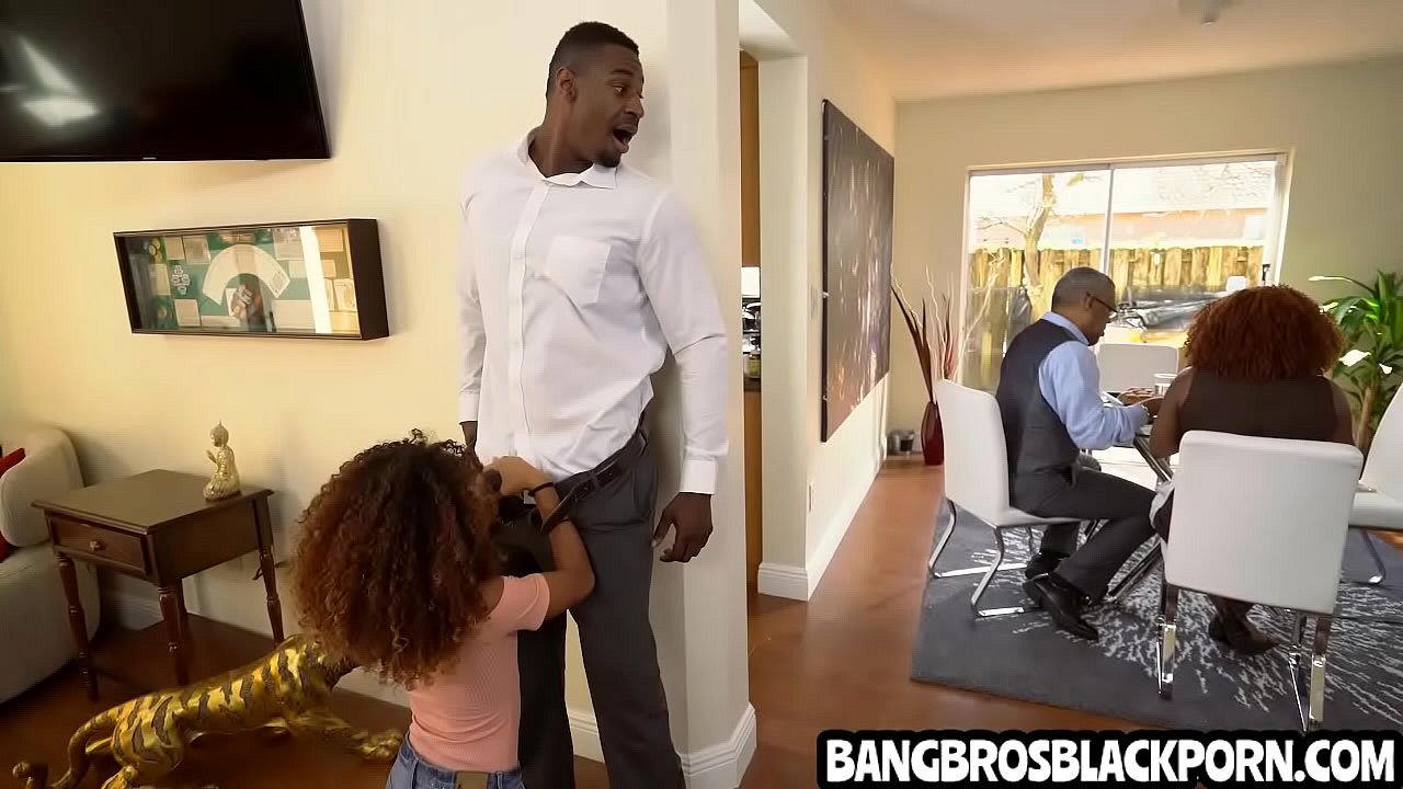 Black teen sucks her step dad while her step mother is talking with her step grand-father in the kitchen.