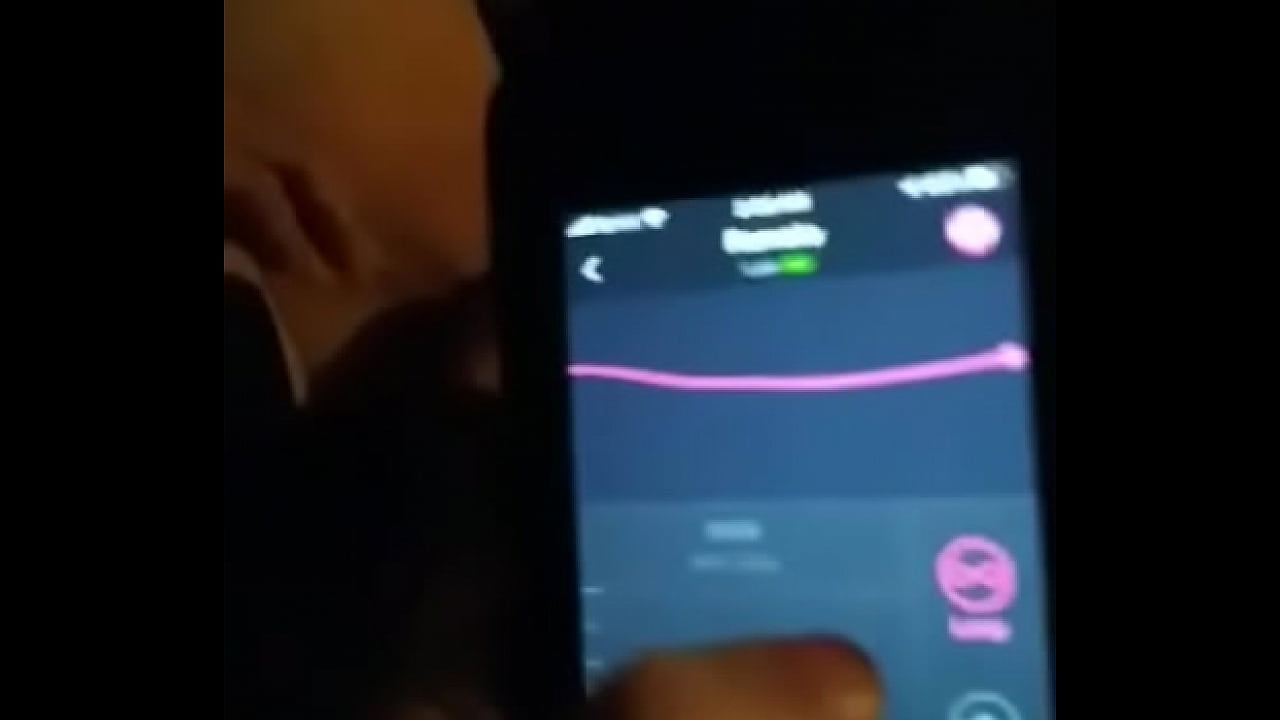 Young women Pleasing and vibrating her pussy while he uses the phone App at home