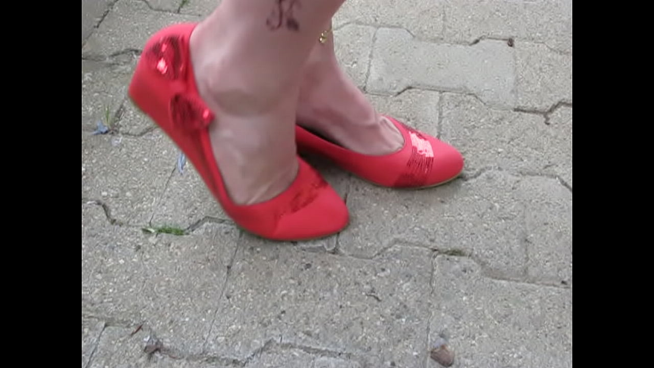 French Queen of shoeplay shows her red leather pumps