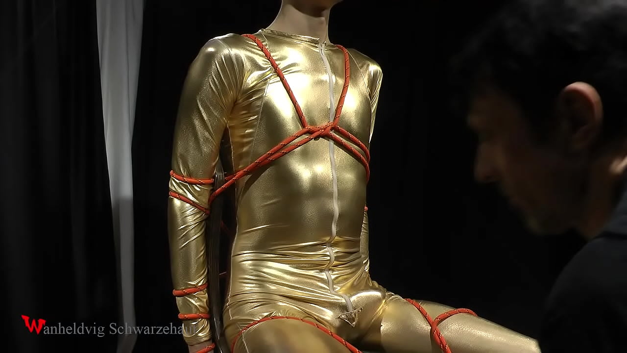 In this clip, Nicky is wearing a gold jumpsuit