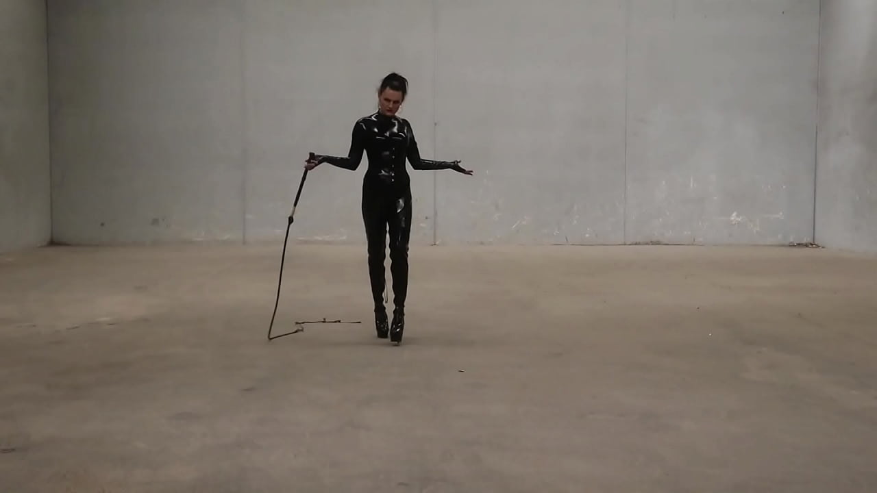 Trans Goddess Obsidian show of her bullwhip ing skills as she struts around in her latex catsuit.