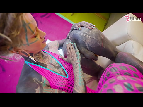 Tattooed dominatrix in pink Fishnet