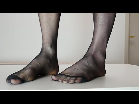 Feet in black nylon stockings