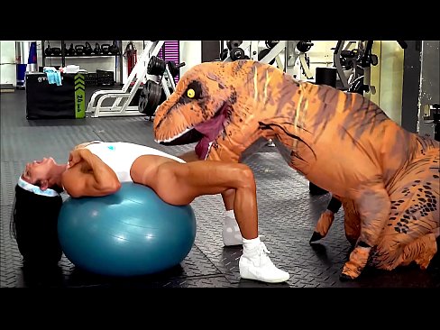 Hardbodied milf gets railed by a fucking dinosaur in a gym