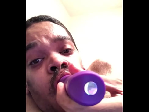 Sucking on a dildo