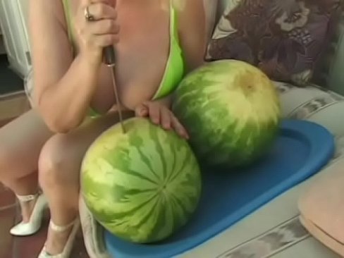 Meaty blonde with huge jubblies is making blowjob through piece of watermelon