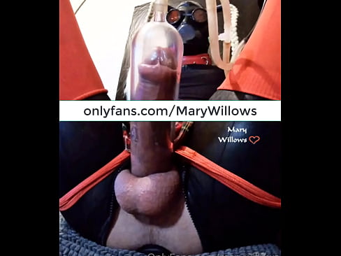 Mary Willows handsfree vacuum milking while gimp is wearing a latex mask