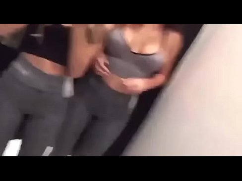 Two hot chicks licking each other in dress room