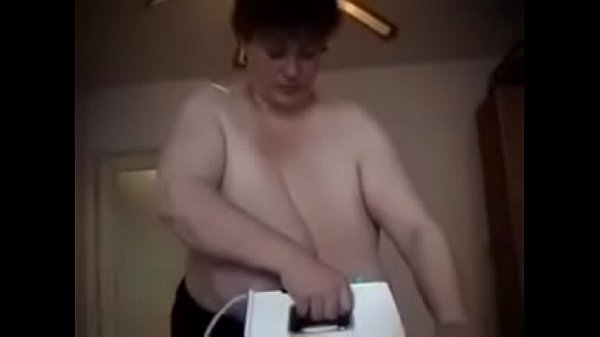 Mature huge breasted cow doing the ironing