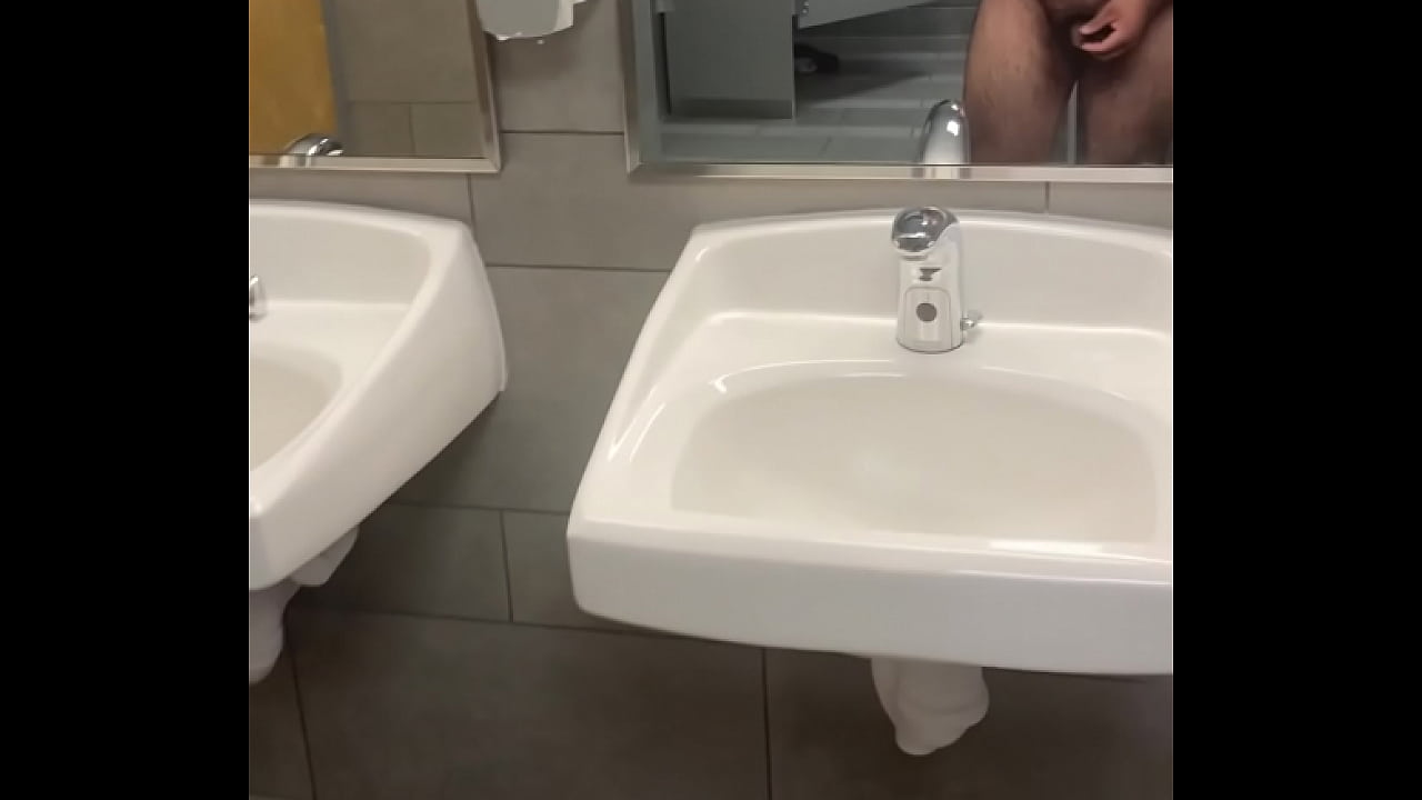 Jerking off completely nude in a public bathroom and cumming on the floor