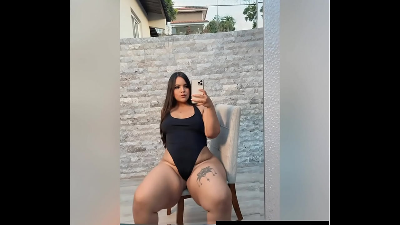 A girl with huge hips masturbates in the yard