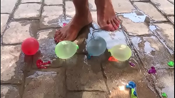 Foot fetish crushing water balloons with heels