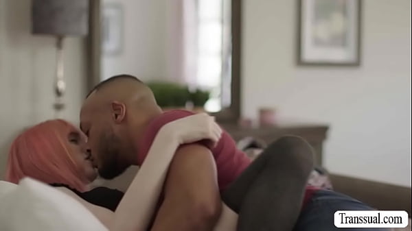 Stepbro Dillon Diaz and hes big tits TS stepsister Mimi Oh are on the bed kissing each other.  