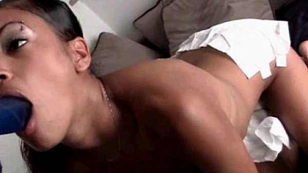 Ebony slut masturbating using huge dildo