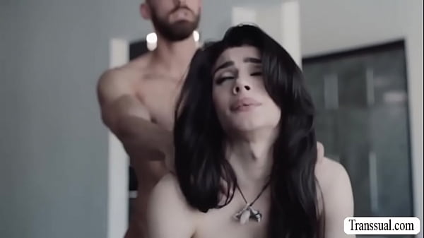 Stunning shemale and her boyfriend are on the couch kissing each other.After that,she throats his cock and rides it.  