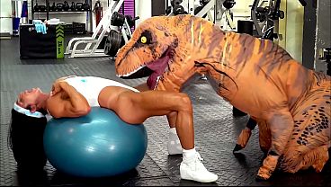 Hardbodied milf gets railed by a fucking dinosaur in a gym