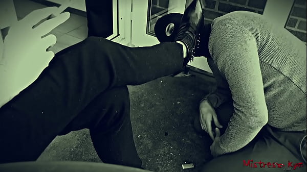 Domme smoking while sub is licking her black shoes