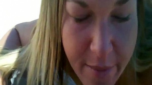 Blonde MILF blowing her mans cock in the backyard 