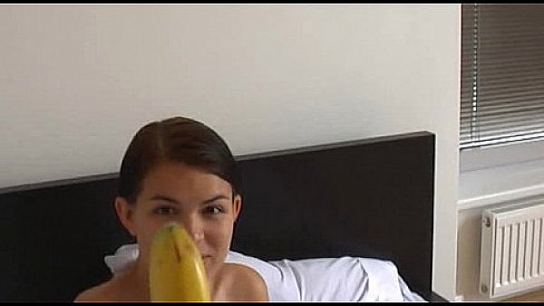 How-to: Young brunette girl teaches using a banana