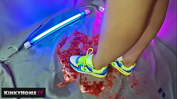 The girl crushes the strawberries with sneakers NIKE AIR