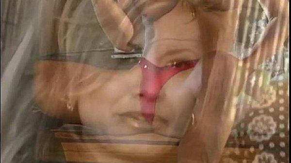 Nude redhead dances against pillar