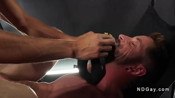 Johnny Ford laying in a sex swing and fingering ass hole while Elliot Finn jerking cock and watching him then shoving big cock up his ass