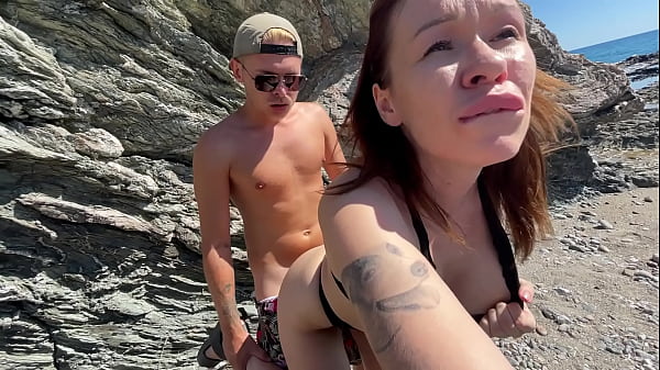 Hot brunette fucks a stranger on a public beach
