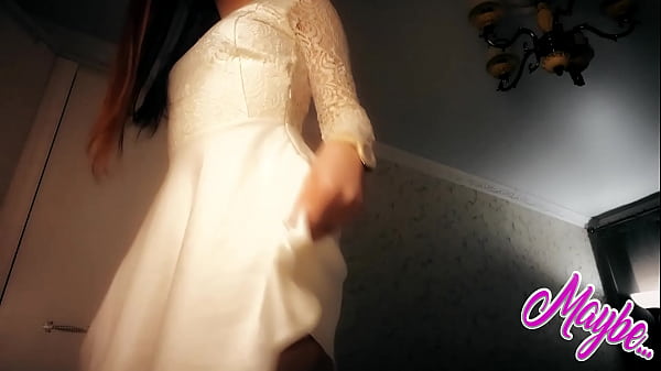 Lovely girl in a white dress makes himself nice  