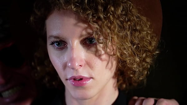 Red curly hair in the hands of a voluptuary