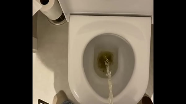 Uncut cock taking a piss into the toilet  