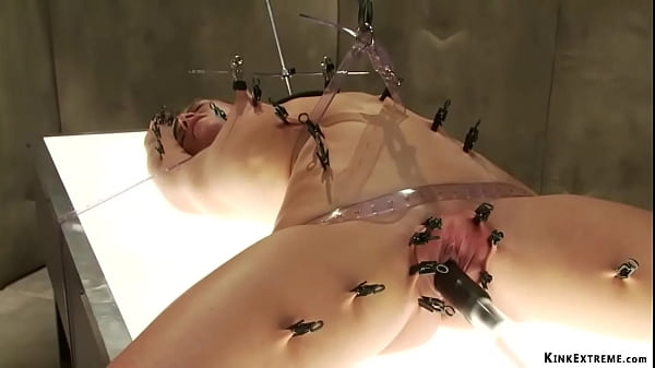 brunette MILF slave Ariel X in laid on illuminating table and clamped then machine fucked till tormented in black straitjacket at Psycho Ward