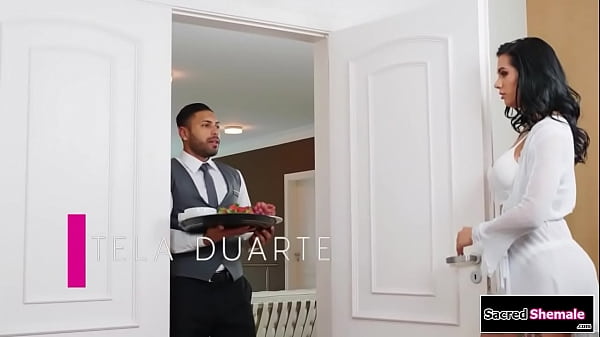 Latina shemale Estela Duarte asks a bellboy to fuck her and the guy licks her feet.He gives the tgirl a bj and then the big tits trans barebacks him 
