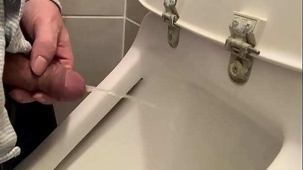 Man using urinal  
