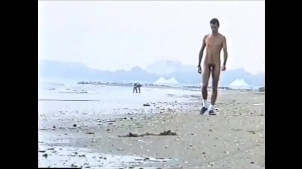 amatorial young boy walking naked on the beach