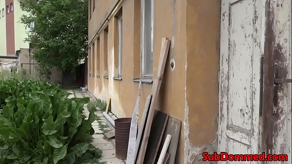 Caged bdsm sub gets cock tugged outdoors 