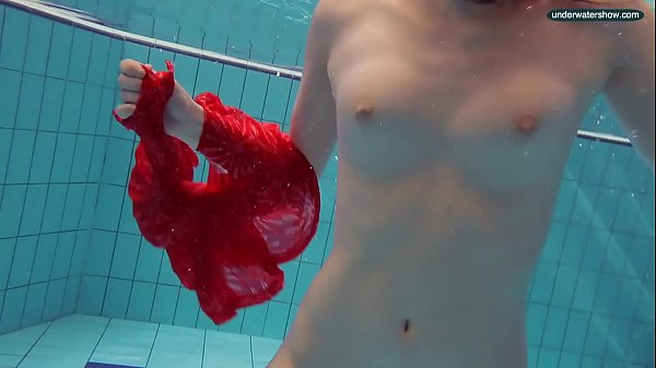 Red Dressed teen swimming with her eyes opened