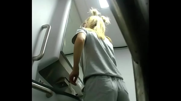 Skinny in short shorts pees in the train toilet