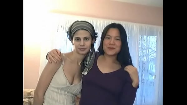 Interracial lesbians play with dildo on the living room floor 