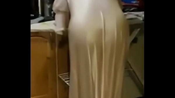 Wife in her satin nightie ironing  