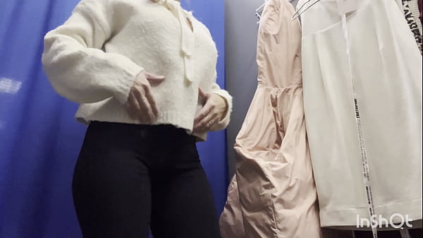 A naked woman in a public fitting room  