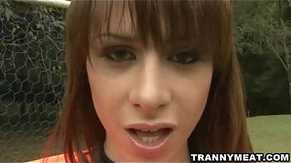 A sexy tranny on a soccer field masturbates