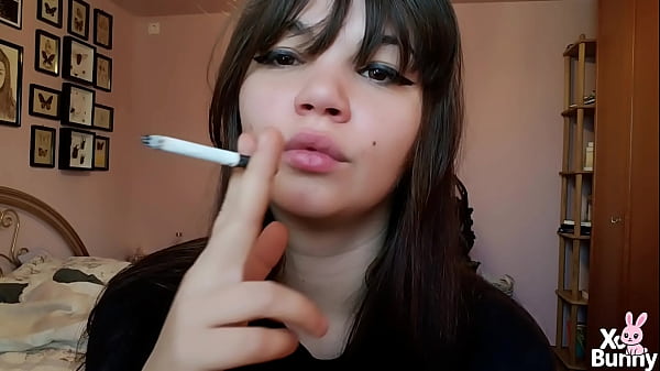 Brunette with natural big lips smoking without lip makeup  