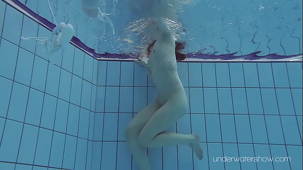 Floating babe in the warm pool getting naked