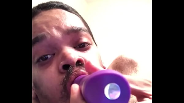 Sucking on a dildo