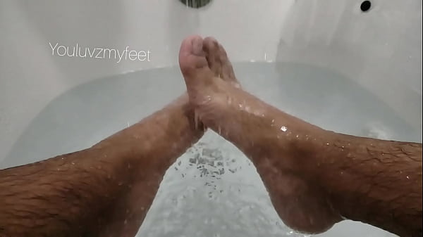 Slowmo man feet bathtub  