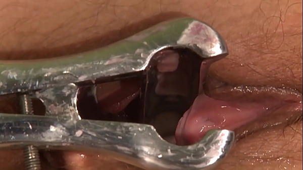 Her doctor canings her cunt, then penetrates her cunt with his big dildo.