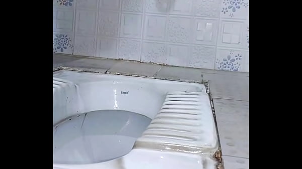 Caged sissy slave pissing outdoor while plugged  