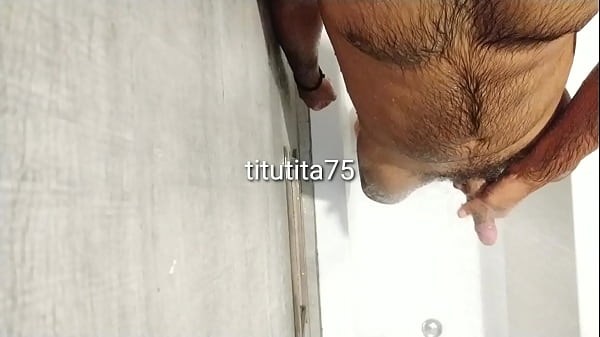 Cleaning body and cock in shower 